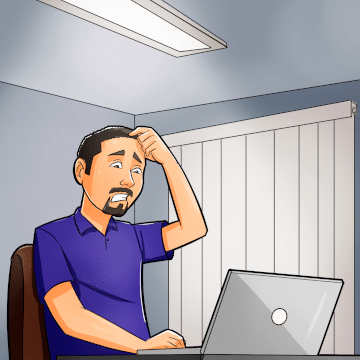 Man sitting at laptop with a look of frustration on his face as he scratches his head