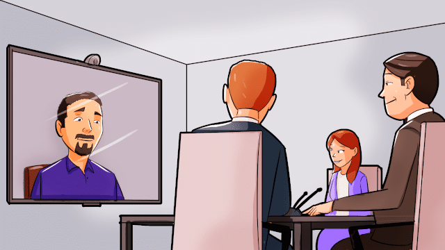Image of man on a screen with three business people sitting around a table